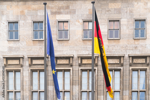 Berlin, Germany - January 18, 2017: Flags of Federal Republic of Germany and of European Union waving in front of Federal Ministry of Finance in Berlin photo