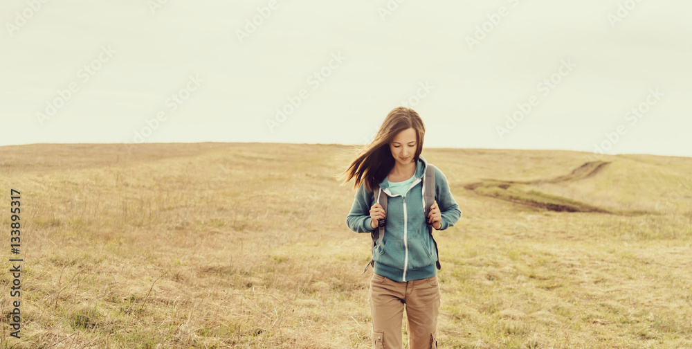 Backpacker walking on meadow