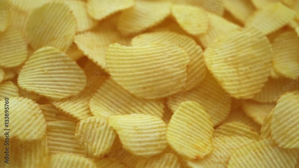 Rotating movin texture of corrugated potato crisps with salt close-up Rotating movin texture of corrugated potato crisps with salt close-up