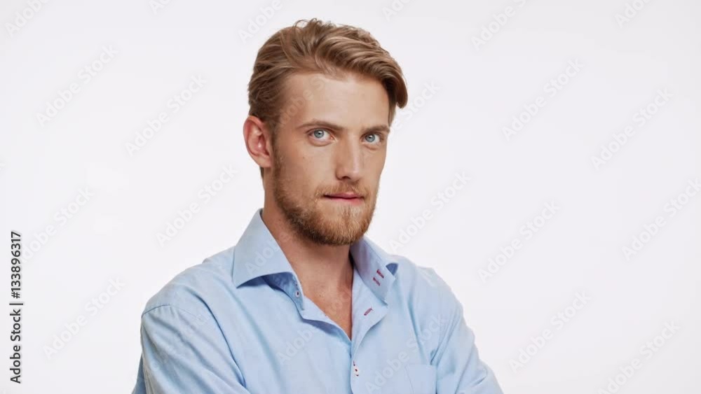 Sexy Caucasian bearded male with blue eyes and brown beard ogles and flirts on white background Sexy Caucasian bearded male with blue eyes and brown beard ogles and flirts on white background