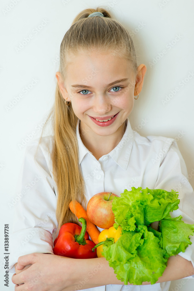 Happy fitness girl holding vegetables isolated