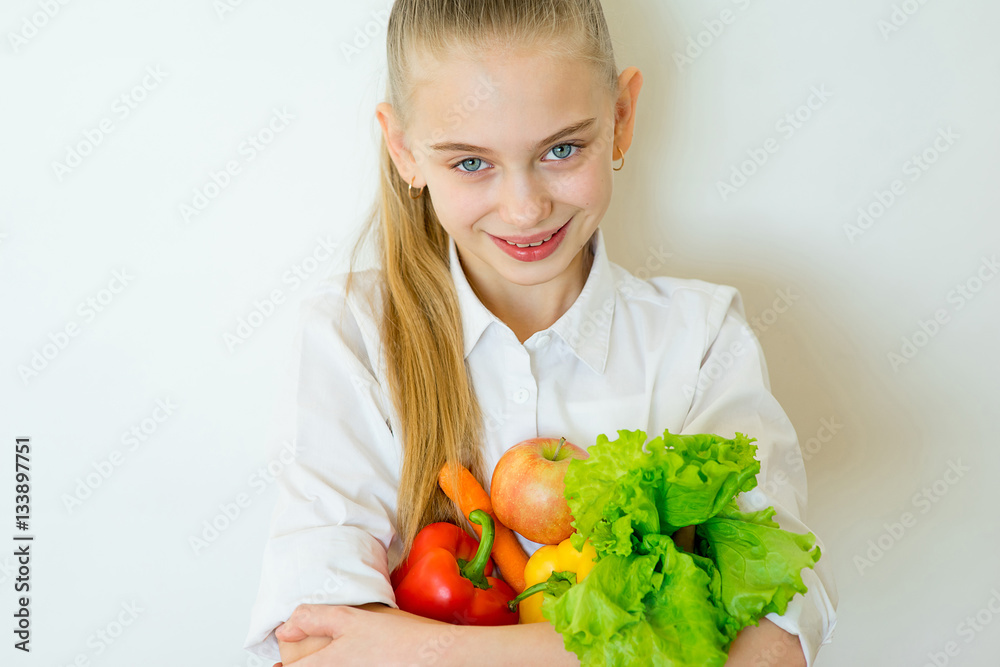 Happy fitness girl holding vegetables isolated Happy fitness girl holding vegetables isolated