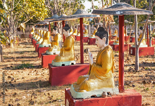 Sitting Buddha statues beneath a Bodhi tree in Monywa, Myanmar. photo