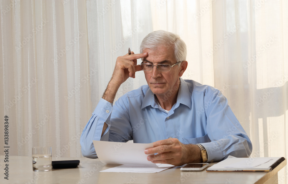 Senior man dealing with financial issues Senior man dealing with financial issues