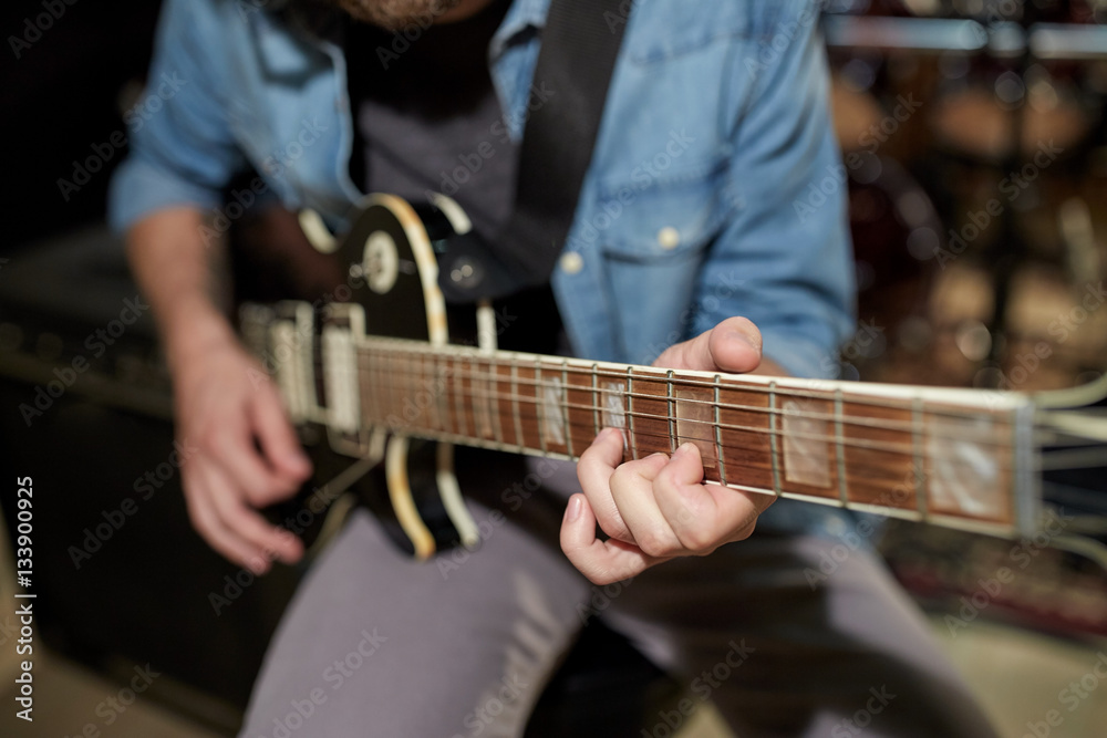 man playing guitar at studio rehearsal man playing guitar at studio rehearsal