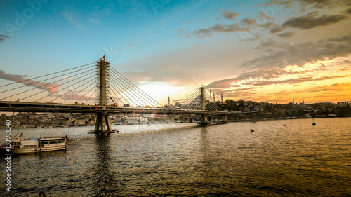 Istanbul  Turkey - April 13  2013  Metro bridge through Golden Horn in Istanbul during sunset  Turkey