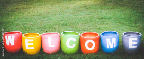 Welcoming and greetings concept with welcome word colorful on garden backgroun