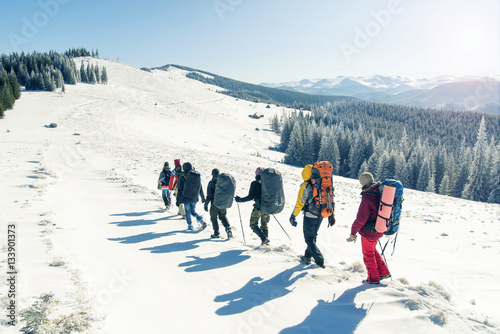 group of tourists walking on tsnow in mountains