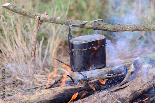 Cooking with cauldron on campfire.