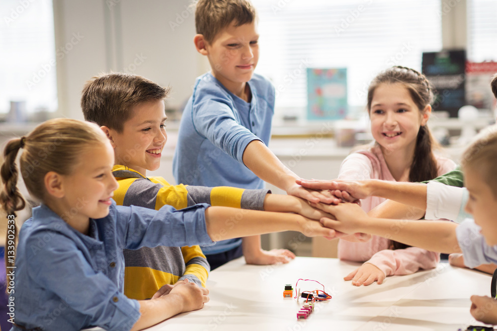 happy children holding hands at robotics school happy children holding hands at robotics school