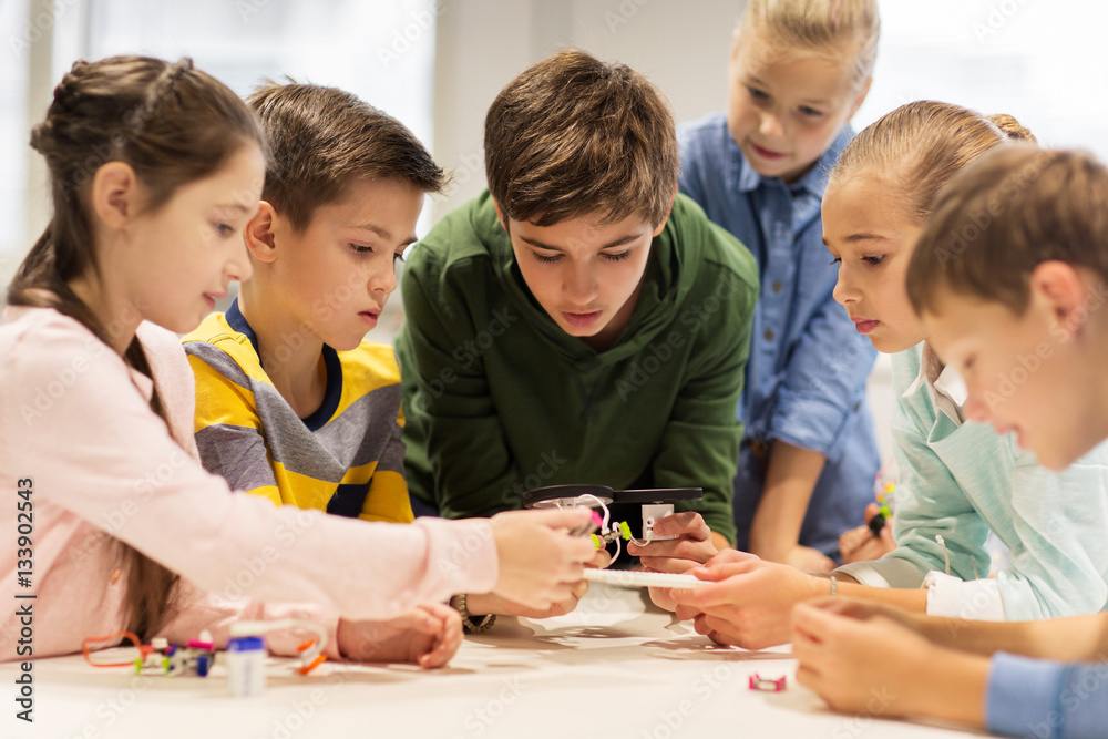 happy children building robots at robotics school happy children building robots at robotics school