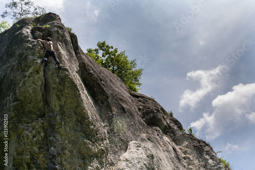 Men climbing vertical wall, Poland