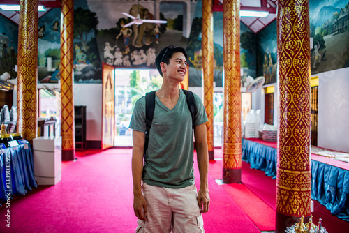 Young man inside Wat Thung Yu Temple, Chiang Mai, Thailand photo