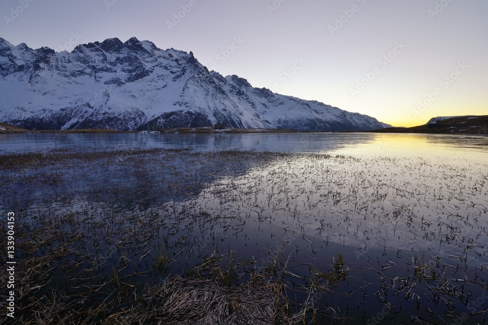 Sunset on the frozen lake du Pontet under the Meije mountain, Écrins massif,  french Alps, France.
