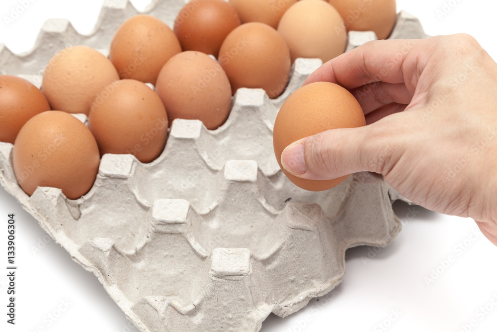 Take some eggs from paper egg tray on white background isolated