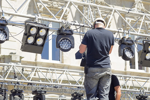 lighting technician installing professional  lighting equipment