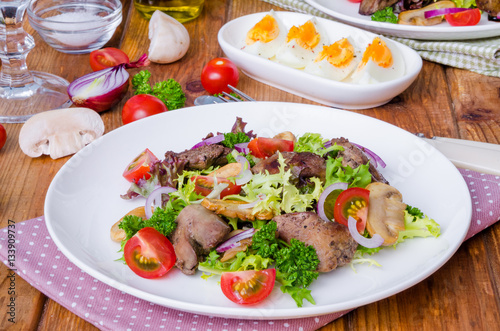 Salad with chicken liver, fried mushrooms and tomatoes