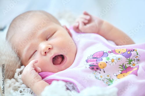 Little newborn baby girl yawns