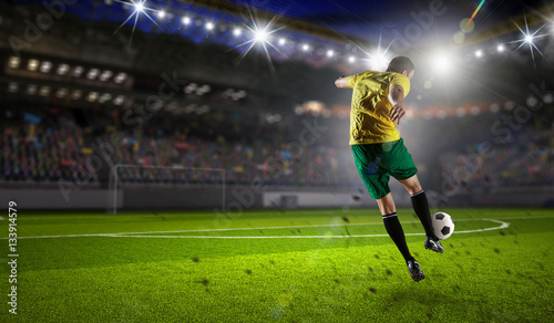 Soccer player at sport arena . Mixed media © Sergey Nivens