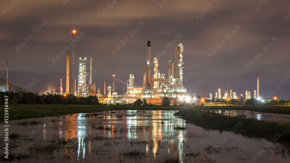 Oil refinery plant at sunrise with sky background