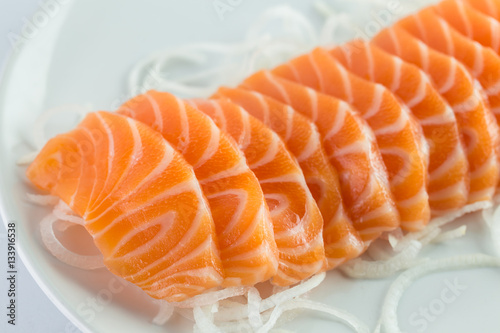 Salmon sashimi, raw on a plate on a white background