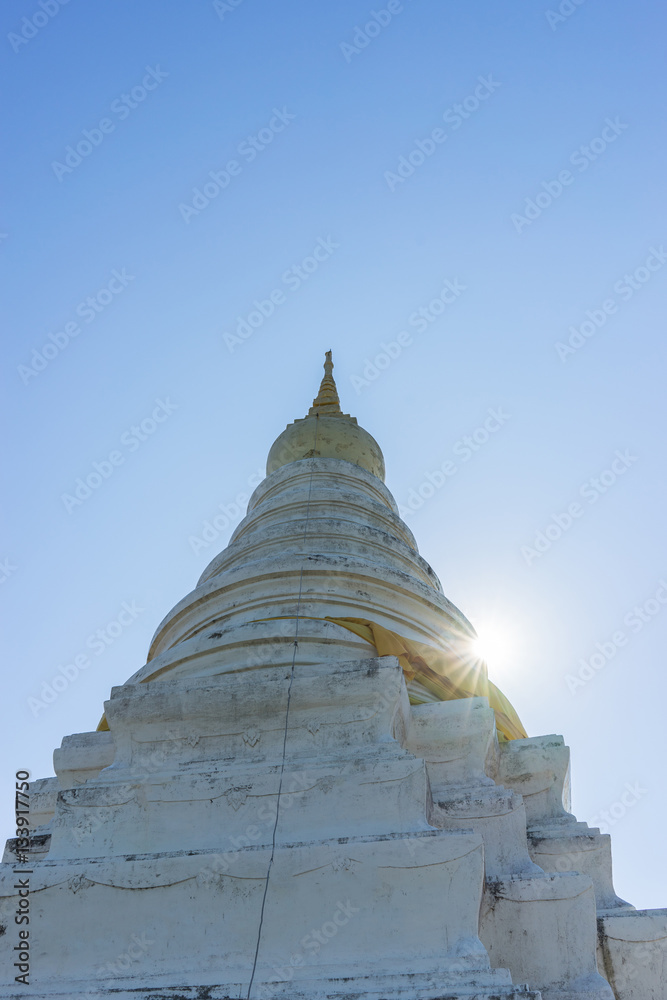 Ancient pagoda in temple with sun beam