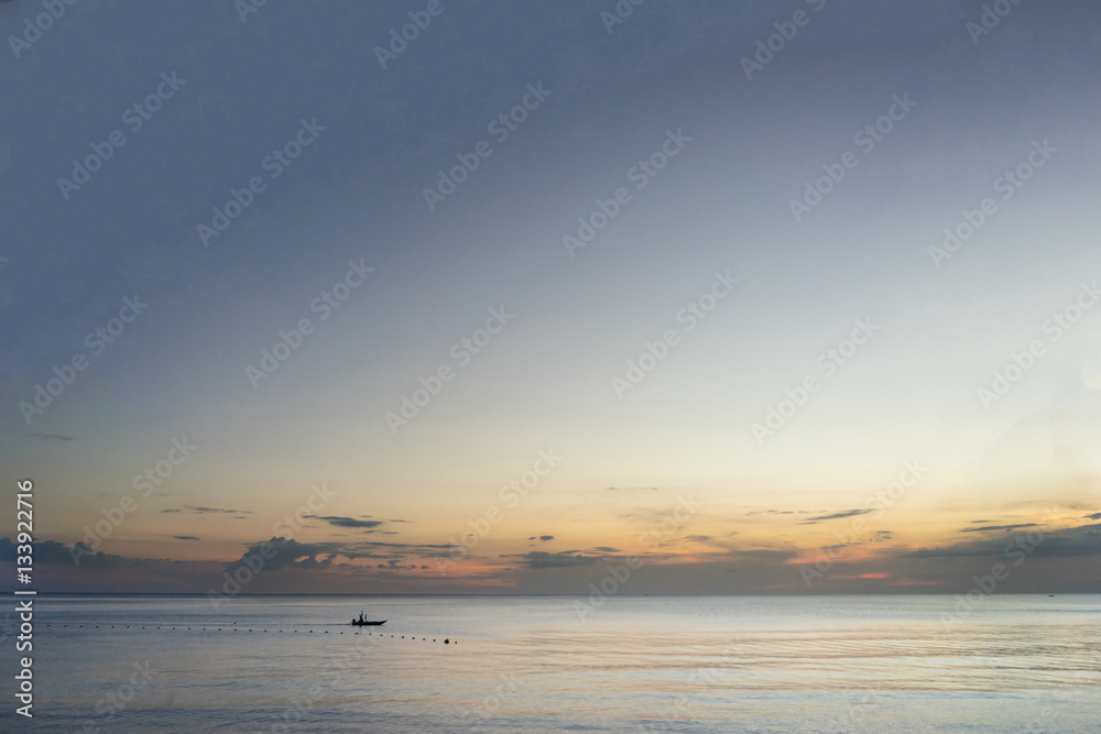 Boat in the ocean (sunset scene)