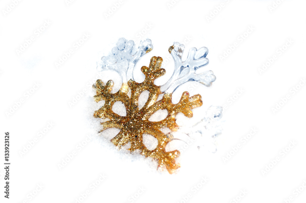 Snowflake golden in snow on white background Snowflake golden in snow on white background