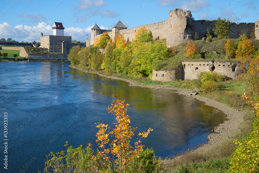 Sunny autumn day on the river Narva. Views of Herman's castle (Estonia) and Ivangorod fortress (Russia)