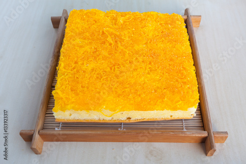 Thai Cake sweetmeat made of egg yolk on wooden table. photo