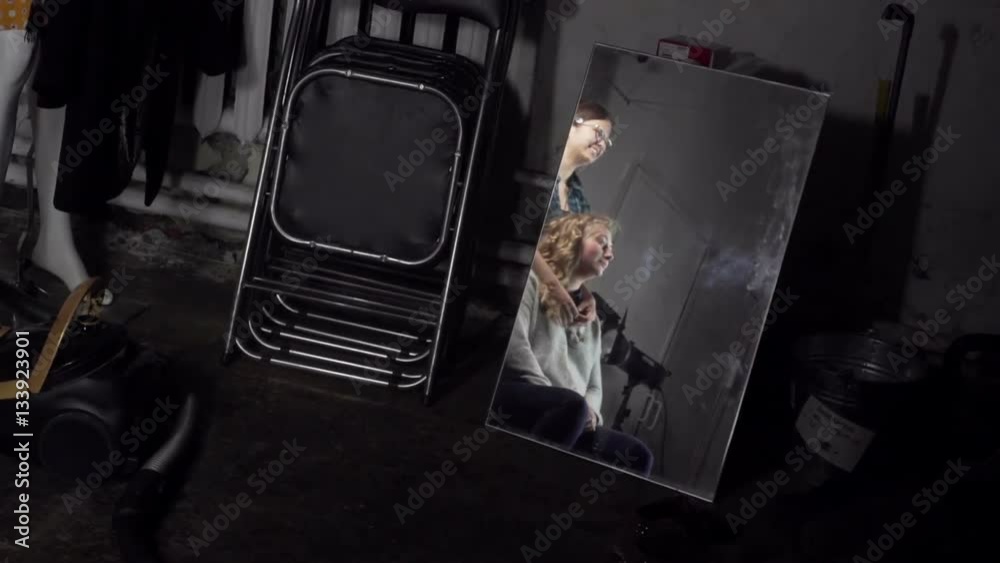 Reflection of two young girls in a mirror during a photocall Reflection of two young girls in a mirror during a photocall