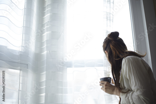 Woman at home waiting with coffee photo