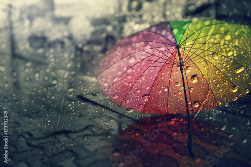 Blurry of umbrella ,view through the window on rainy day.