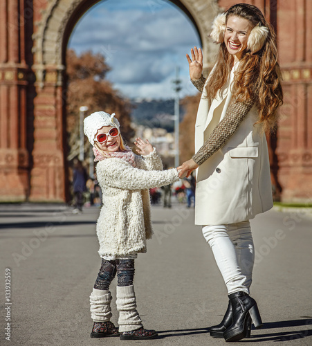 mother and child near Arc de Triomf in Barcelona handwaving photo