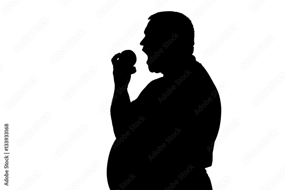silhouette of a man with biting fruit