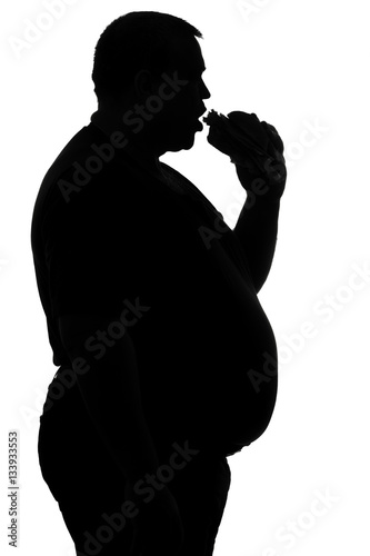 silhouette of a man paunchy eating fast food - photo