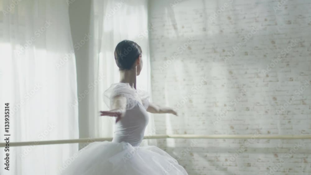 Young and Beautiful Ballerina Gracefully Dances on Her Pointe Ballet Shoes. She's Wearing White Tutu Dress. Studio is Sunny and Modern. In Slow Motion. Shot on RED EPIC-W 8K Helium Cinema Camera. Young and Beautiful Ballerina Gracefully Dances on Her Pointe Ballet Shoes. She's Wearing White Tutu Dress. Studio is Sunny and Modern. In Slow Motion. Shot on RED EPIC-W 8K Helium Cinema Camera.