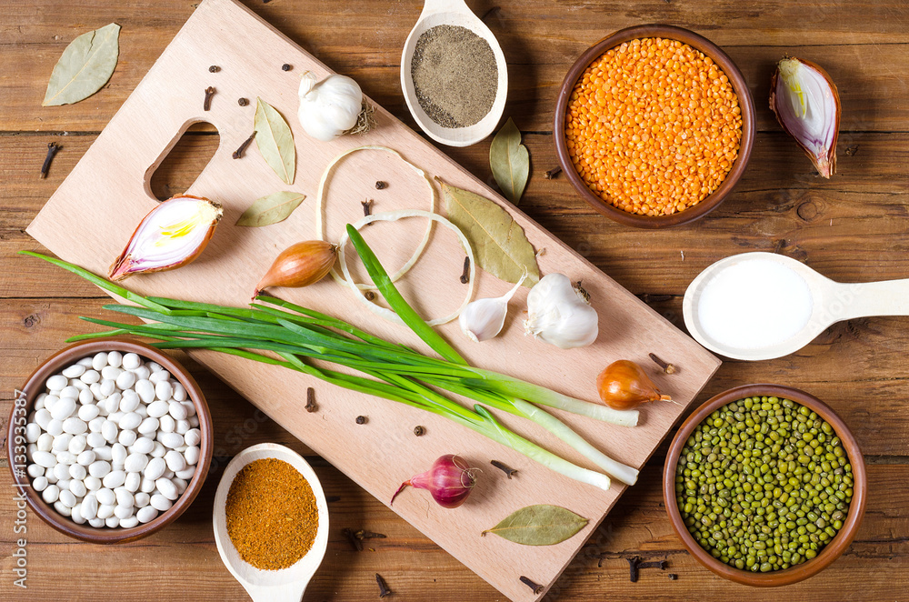 Aromatic herbs, spices and beans on a wooden table. Aromatic herbs, spices and beans on a wooden table.