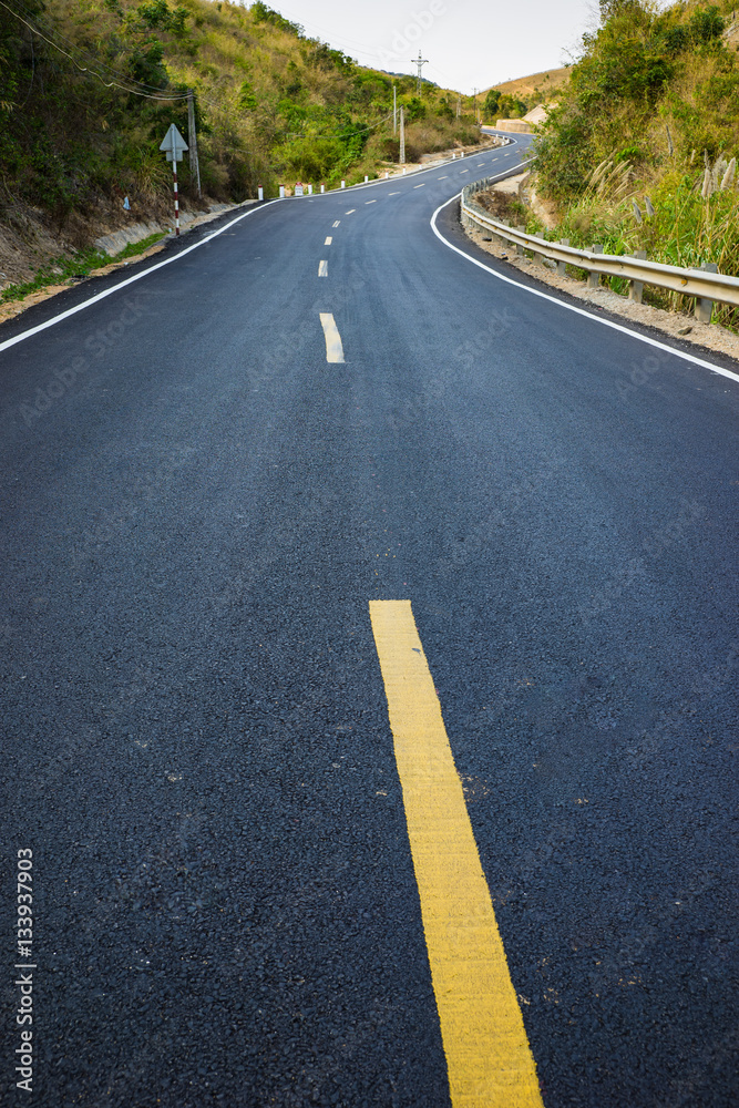 Infinity curved road with yellow line. Concept of adventure, travel, success...