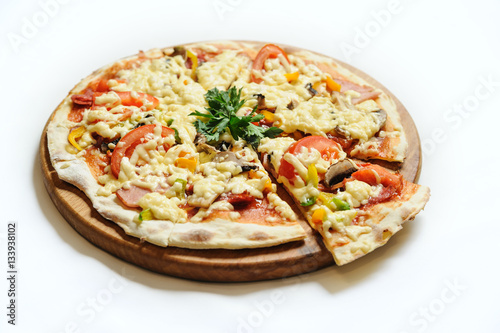Pizza with ham, mushrooms and tomatoes.
