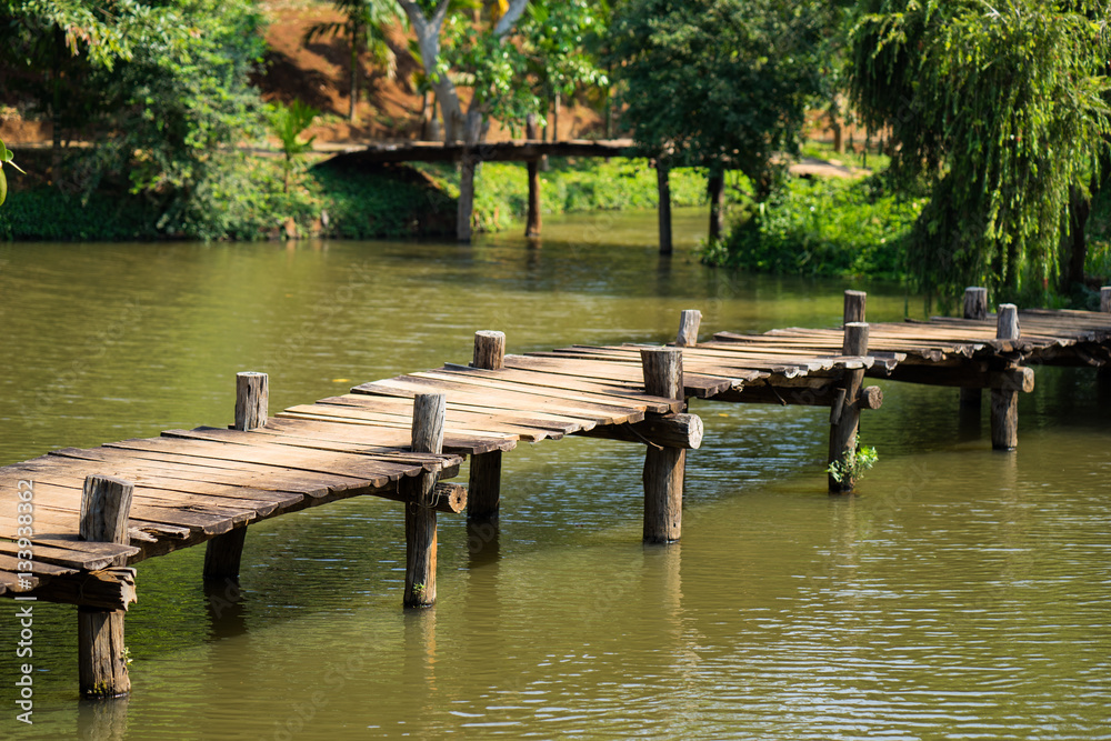 Old walking wooden bridge on lake Old walking wooden bridge on lake