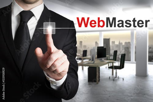 buisnessman in modern it office pushing button webmaster skyline photo