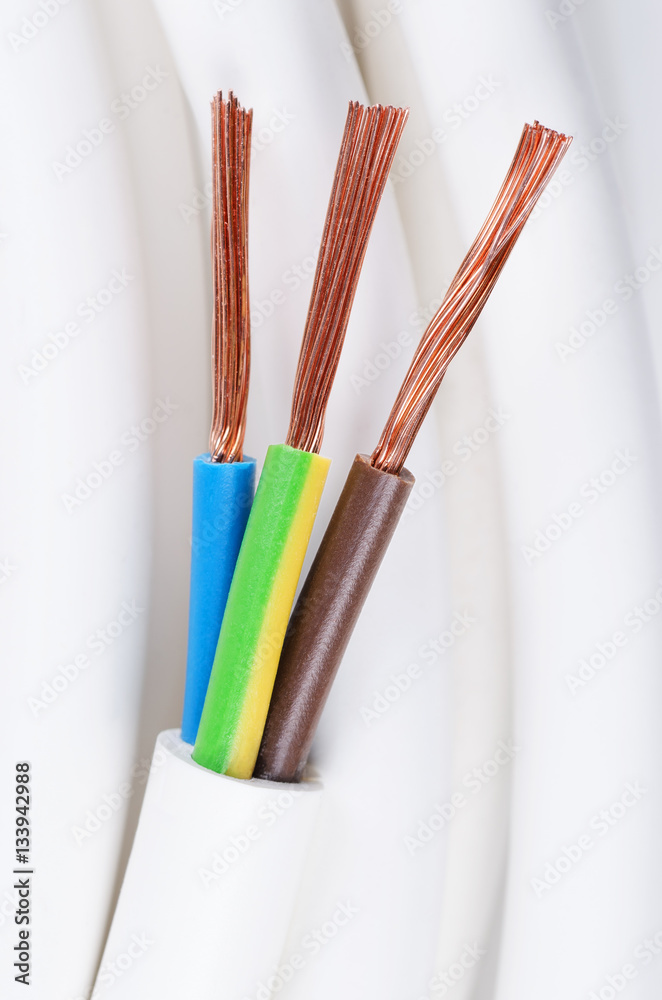 Electrical power cable close up. IEC standard color code. Cross-section  with cable jacket, wire insulations in brown, blue and yellow-green color  with flexible stranded copper wires. Macro photo. Photos | Adobe Stock