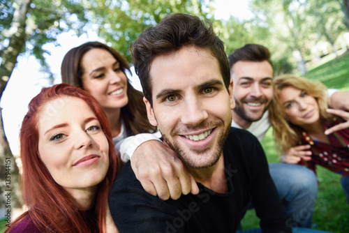 Group of friends taking selfie in urban background