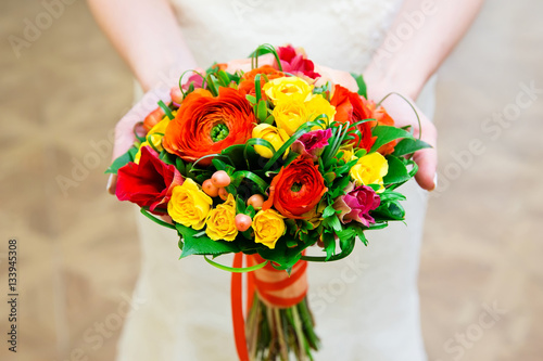 Bride with colorful wedding bouquet