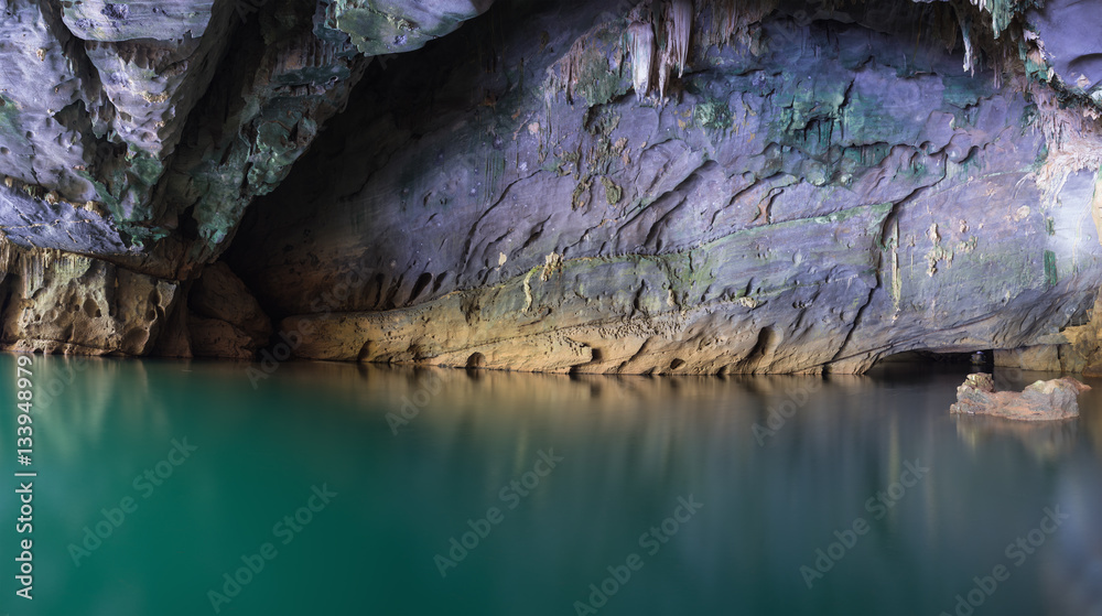 River and rock cliff inside of Phong Nha Cave in Phong Nha-Ke Bang National Park, a UNESCO World Heritage Site in Quang Binh Province, Vietnam