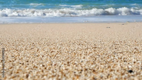Beautiful sand beach and sea waves on sunny day slow motion