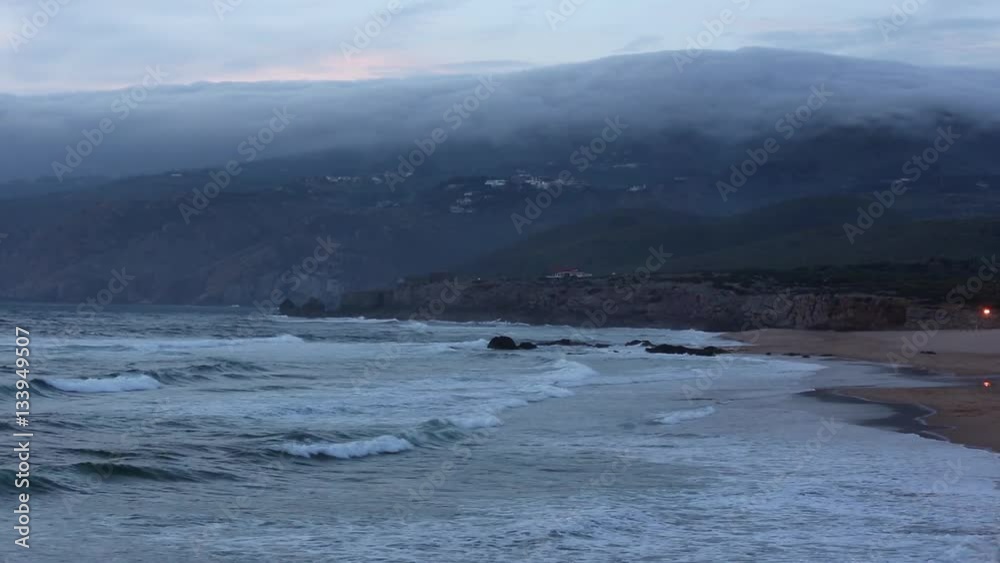 Sunset seascape from beach with ocean surf and gray clouds over Cabo da Roca, Portugal. Visible the movement of the clouds.
Sunset seascape from beach with ocean surf and gray clouds over Cabo da Roca, Portugal. Visible the movement of the clouds.