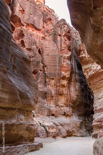 Canyon Siq (Al-Siq) located at Rose city - Petra, Jordan. The road in the canyon leads to Al Khazneh (Treasury) temple.