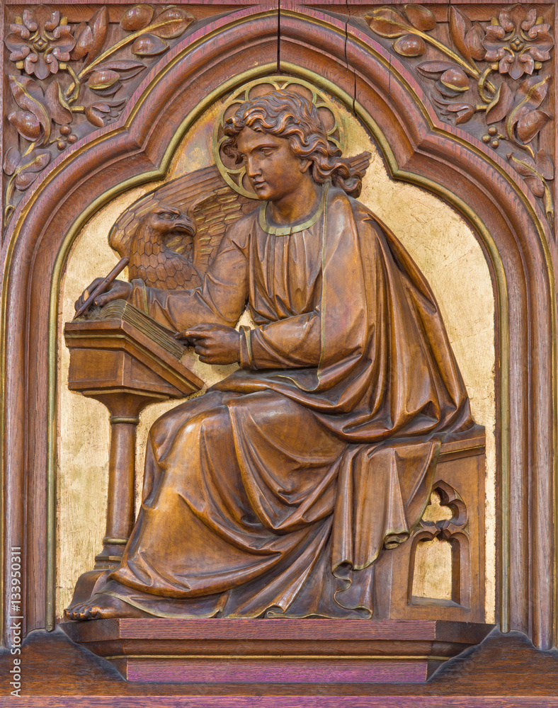 VIENNA, AUSTRIA - DECEMBER 19, 2016: The carved relief of St. John the Evangelist in church Brigitta Kirche by unknown artist of 19. cent.